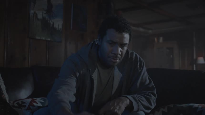 A man is smoking while playing video games