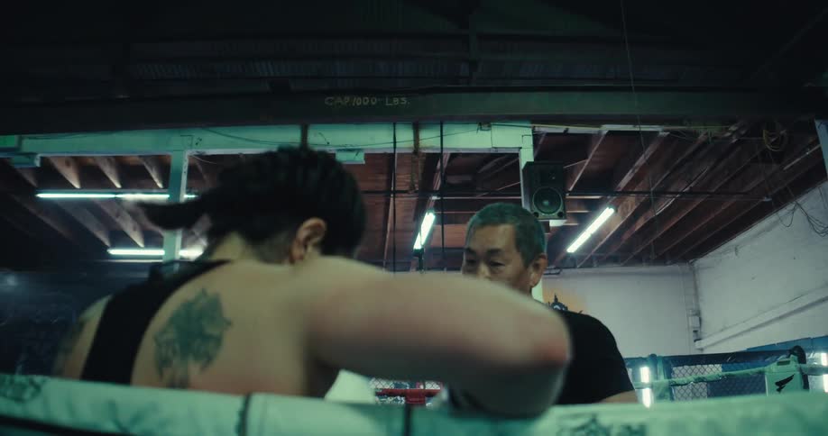 A woman spins around while practicing boxing