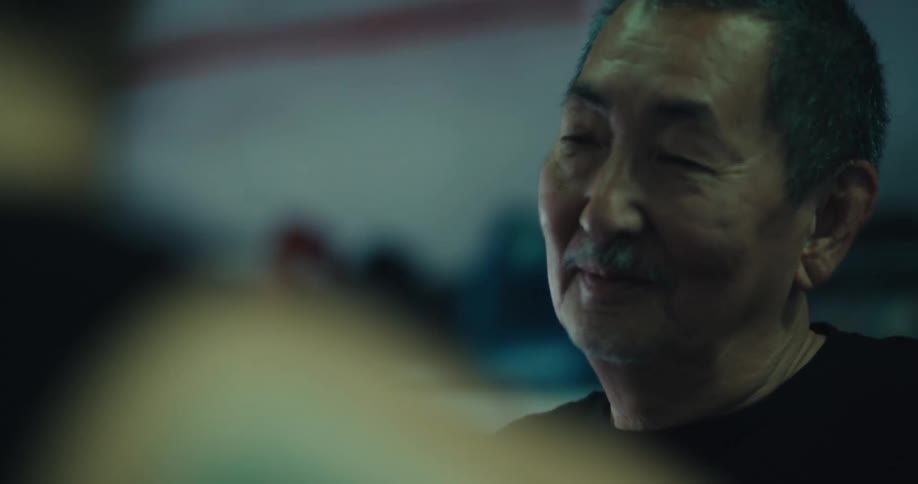 A man is smiling and talking with someone