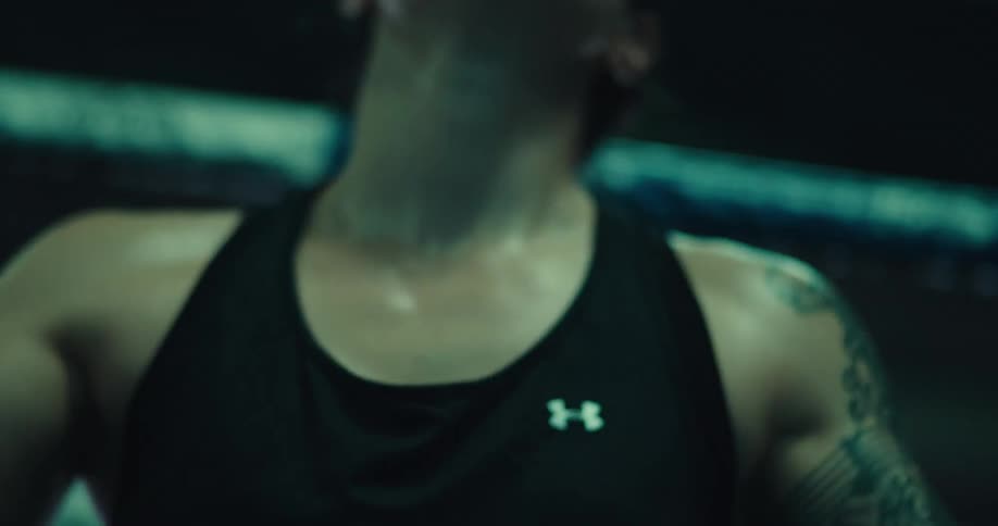 The boxer punches her gloves together in the ring