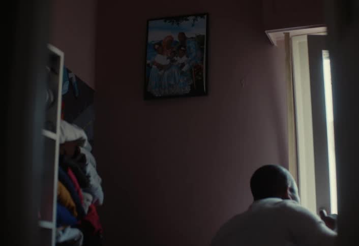 A man opens the window and peeks out