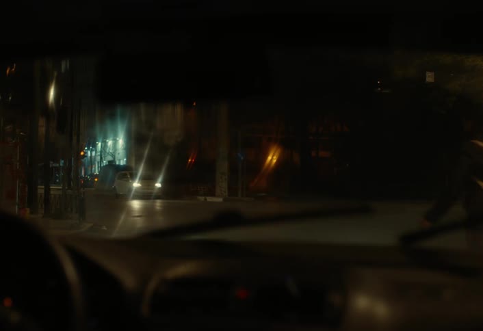 A night footage of a car parked in a busy street