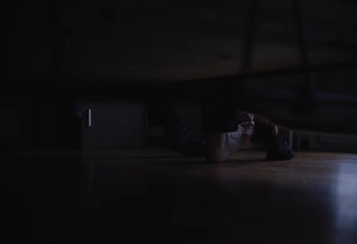 Feet of a person getting out of bed and wearing stockings