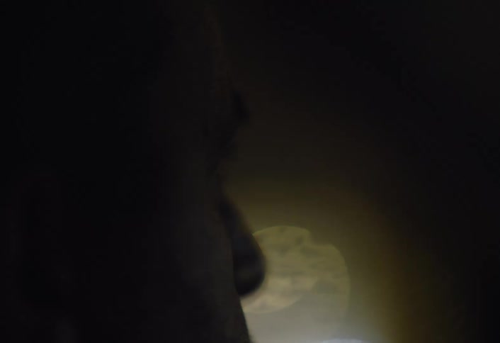 The lights reflect off the glass of the car windows