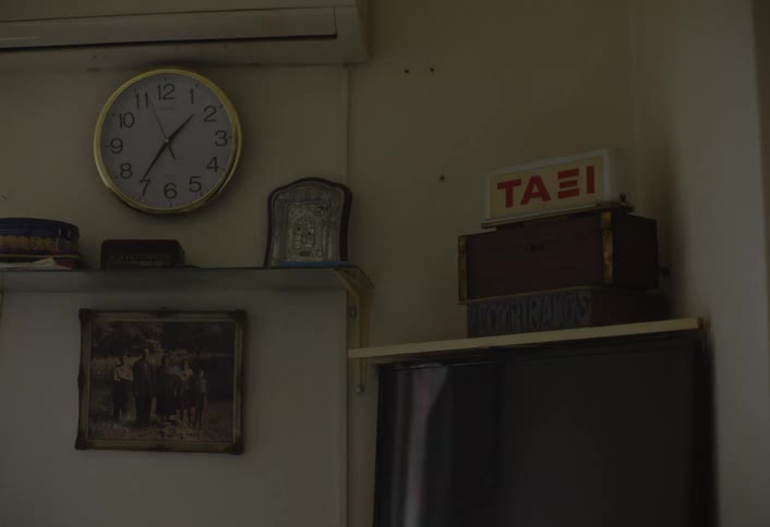 A clock is on the wall above the shelf