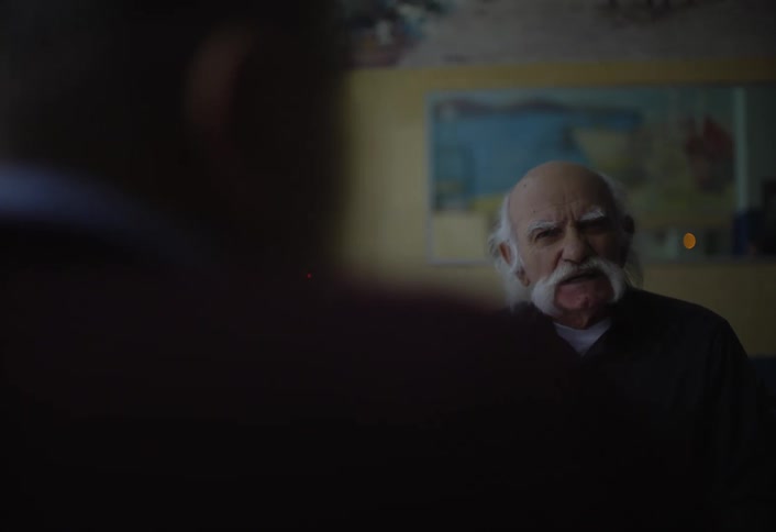 A man is talking with someone while sitting