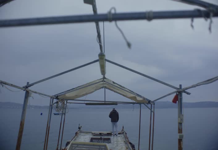 A footage of amen standing by the shore