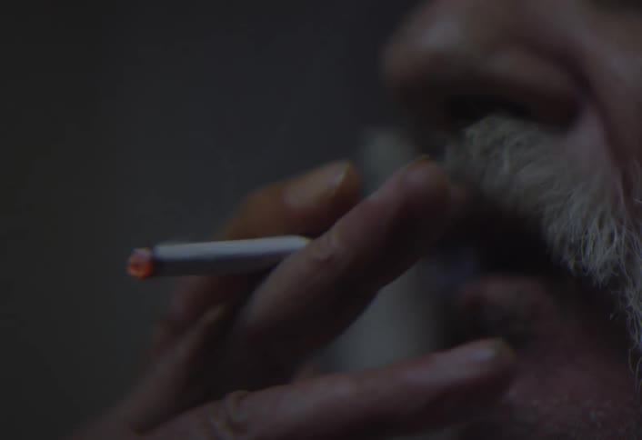 A close up clip of a man smoking