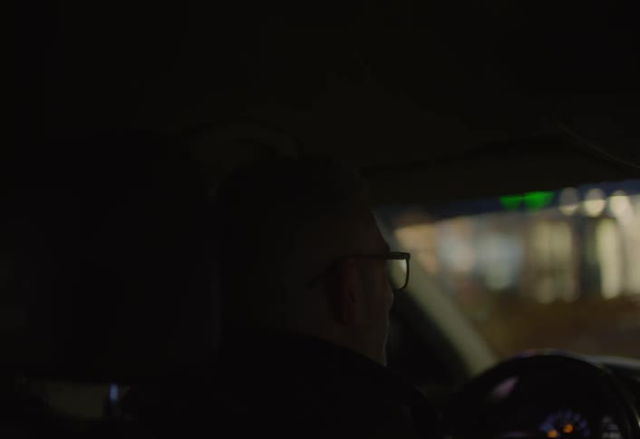A man stops at an intersection to let traffic through