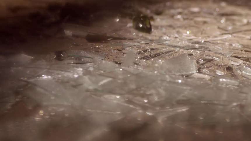 Glass shards fall to the ground