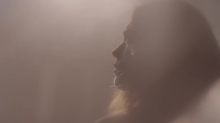Light shines down on a woman's face