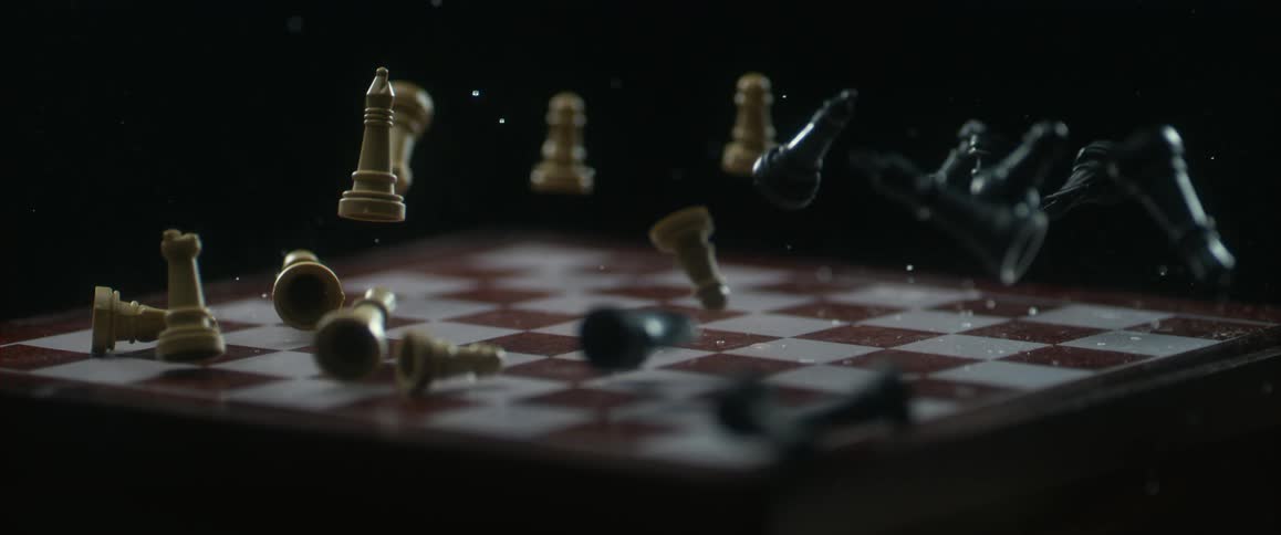 Chess pieces falling onto a chess board