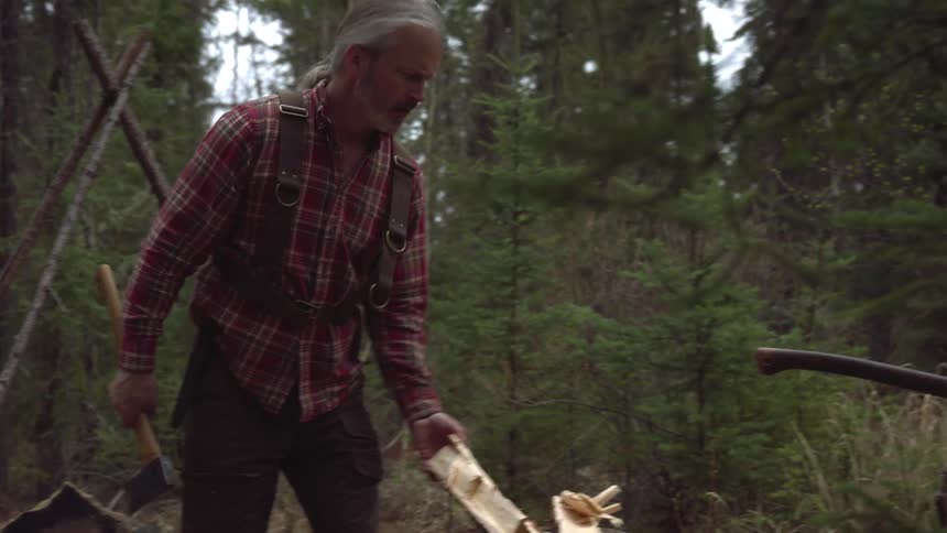 A footage of a man cutting woods
