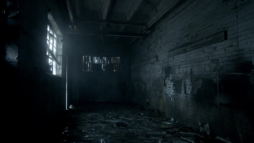 The small dark room has debris all over the ground