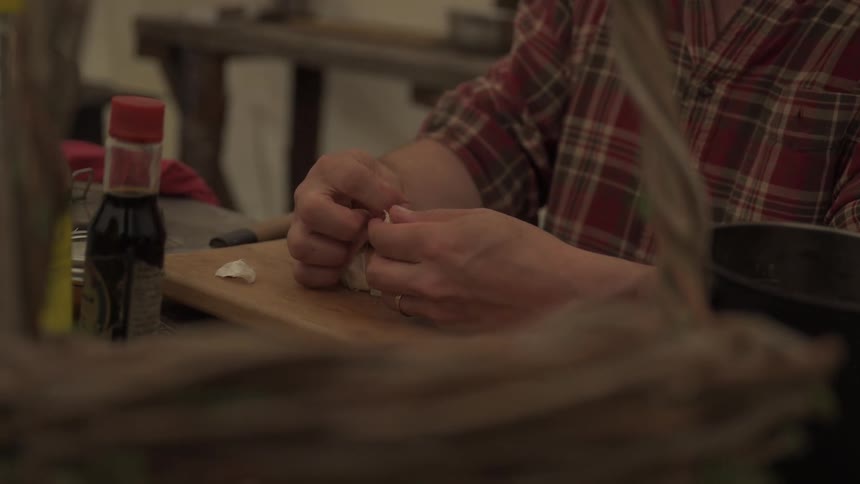 A man is peeling garlic