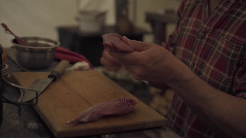 A man is cleaning chicken