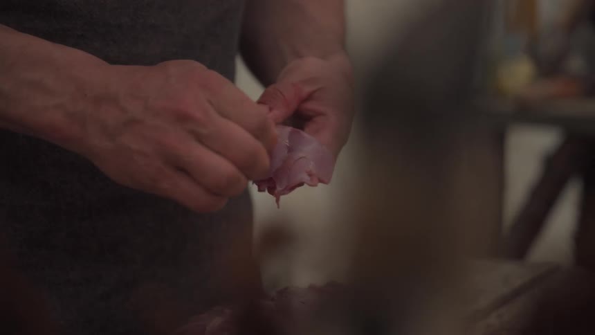 A man is cleaning meat