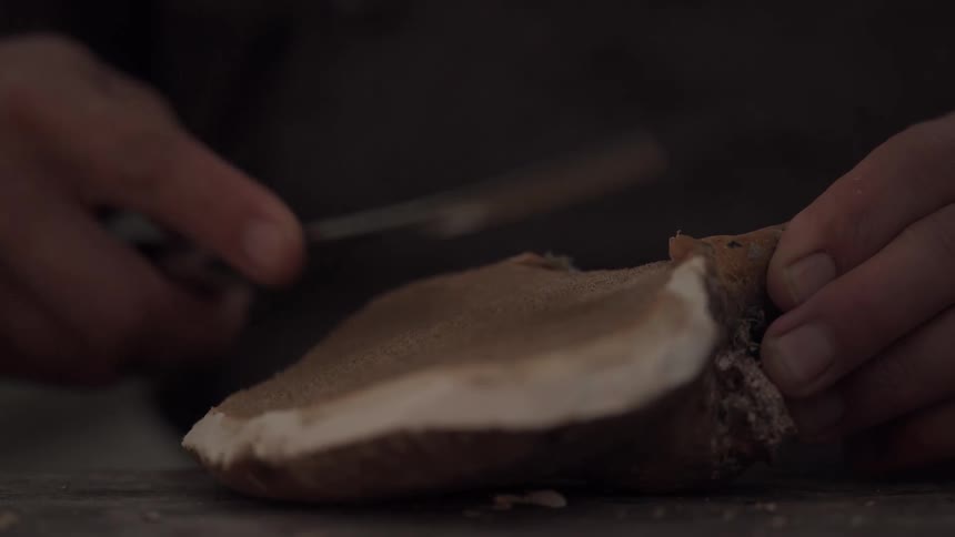 A man is sharpening his knife