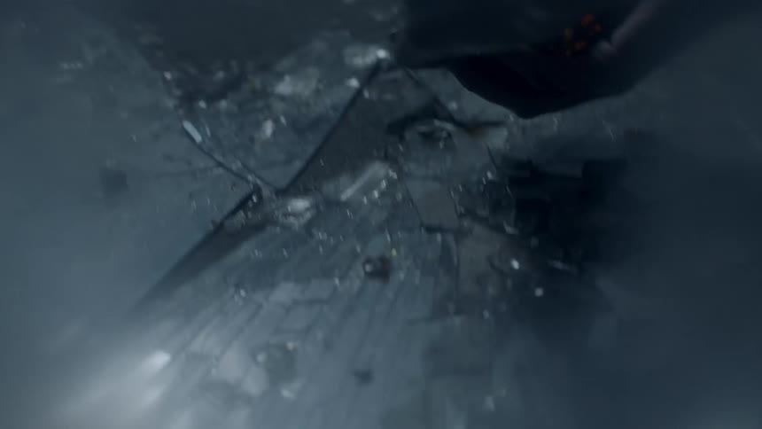 A person is picking up glass from the ground