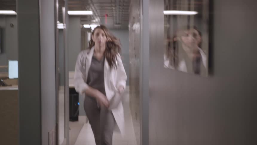 A footage of a lady walking the hospital corridor