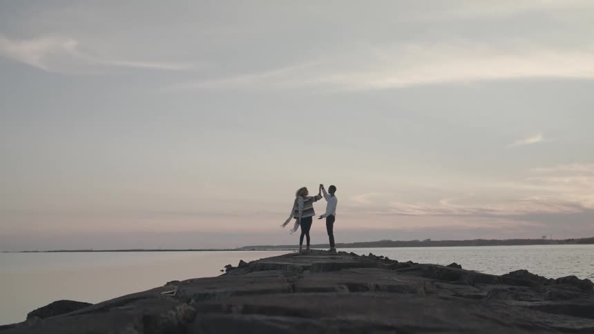 A couple dances on the jetty