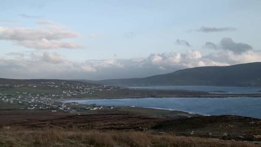 Clouds move fast over this shoreline