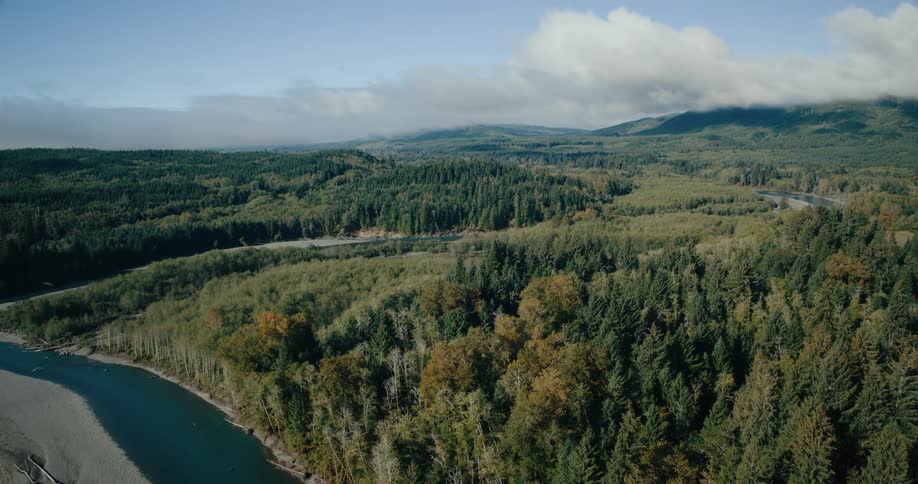 Hovering over the forest mountains and rivers on a cloudy day