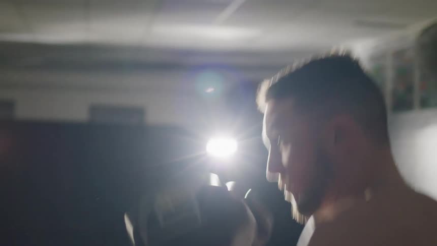 A boxer is throwing punches in the gym