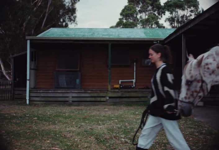 A woman walks her horse around