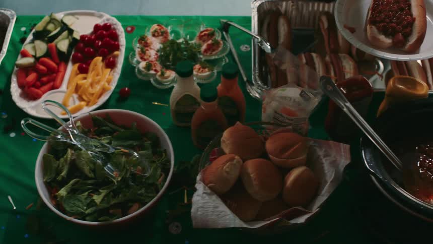 A man serves himself food from the long table