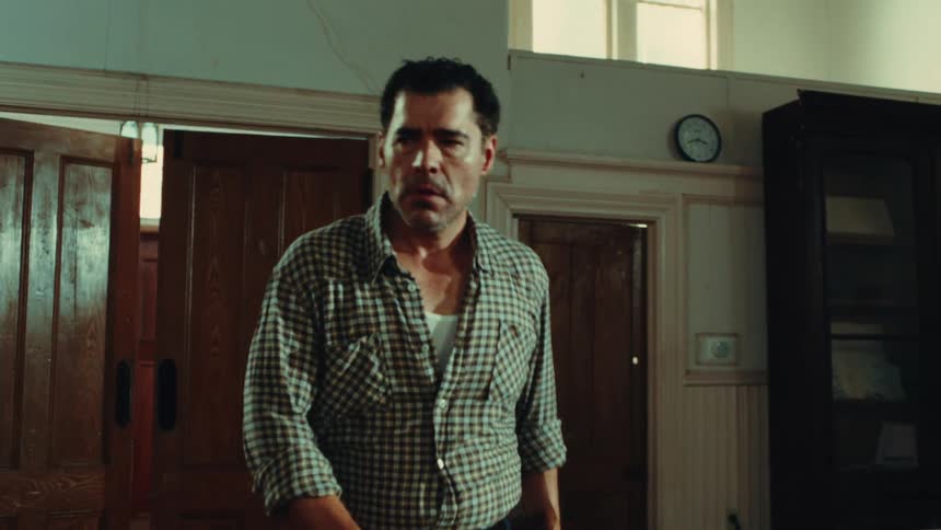 A footage of a man walking indoor