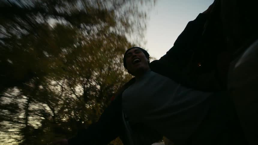 Young man having fun while hanging out the window of a moving vehicle