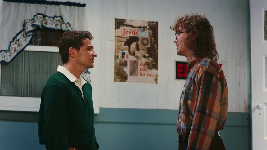 Two friends are talking to each other inside of a house