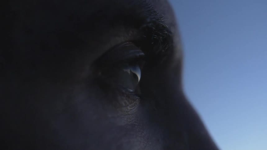 A man is looking forward before blinking once