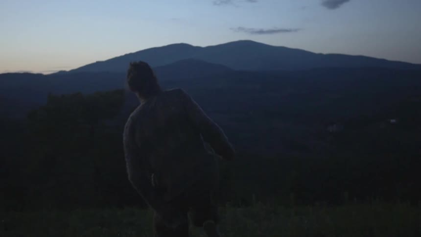 A person is practicing on a field at sunset