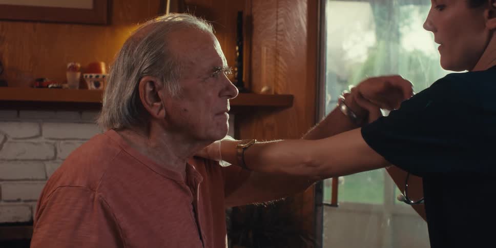 Nurse consulting an elderly patient