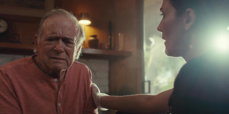 Sad elderly man receiving attention from a nurse