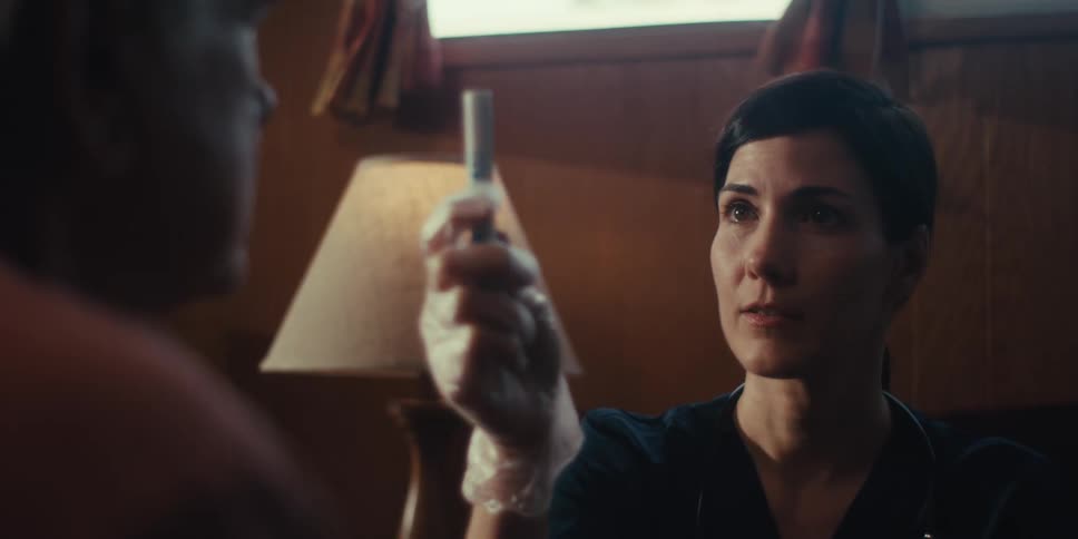 A doctor is testing a womans eyes at home