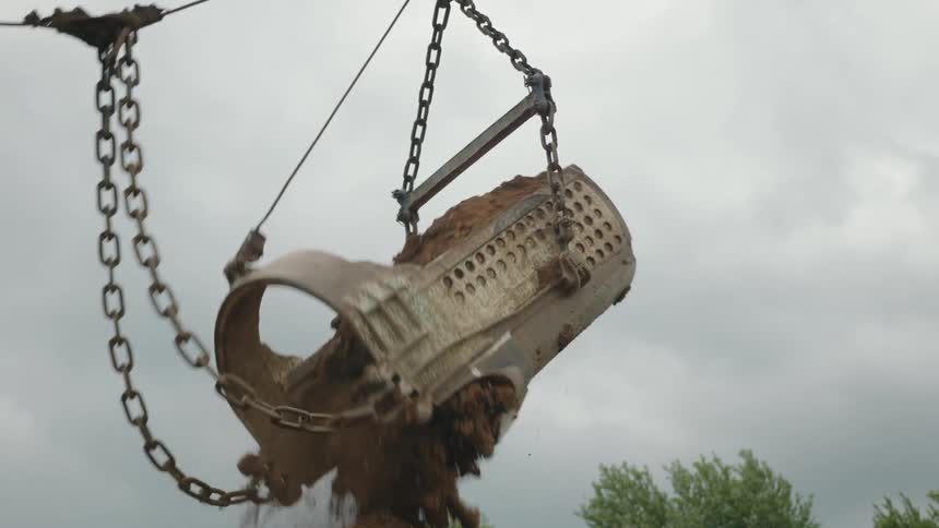 A container dumps dirt