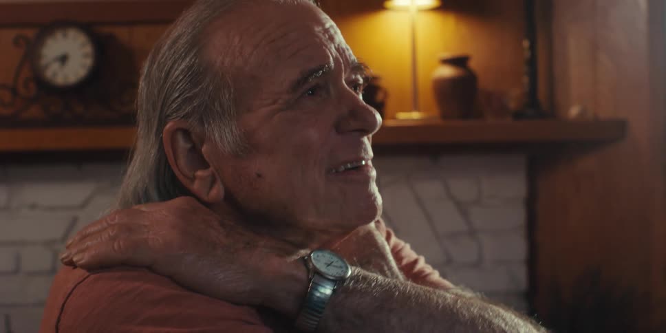Elderly man putting hands on shoulders and talking
