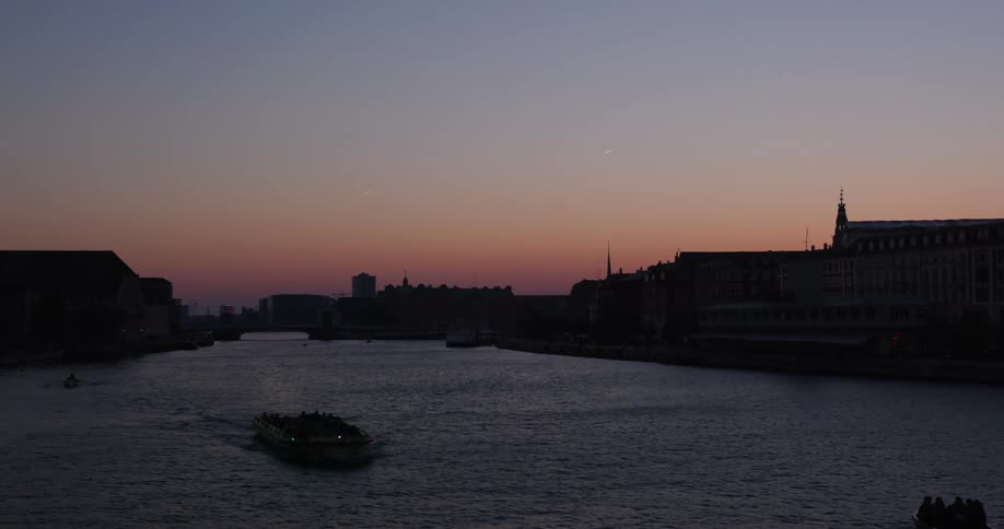 A barge floats down a channel