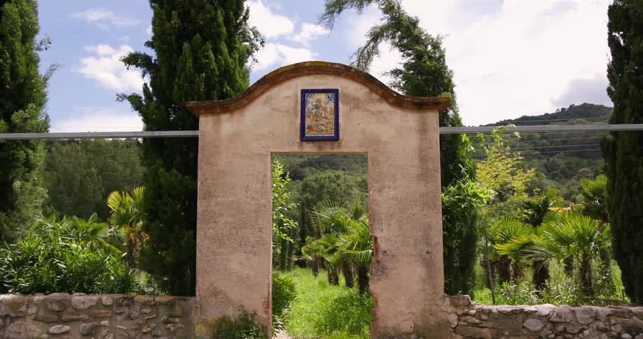 A stone archway with a stone wall on either side