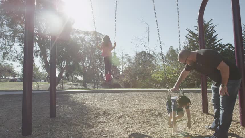 A person standing on a swing