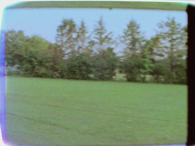 Yard of a mobile home seen through an old camera lens