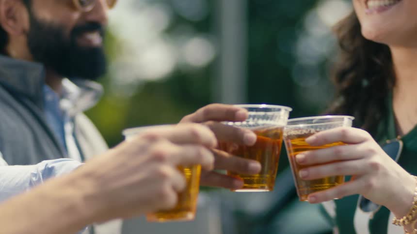Happy man and friends toasting then drinking thier beer