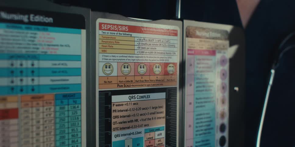 A patient and doctor are pointing at a health chart