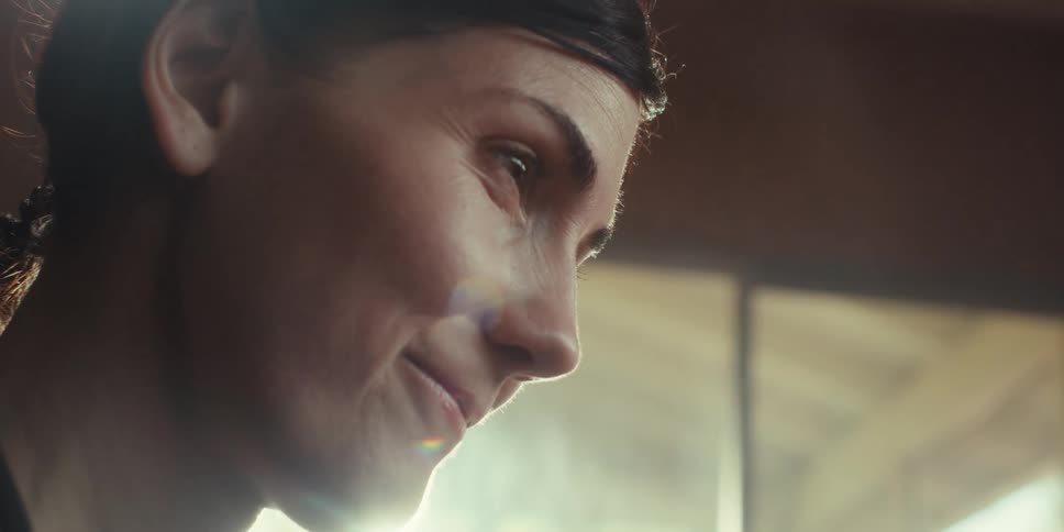 A woman smiles and talks