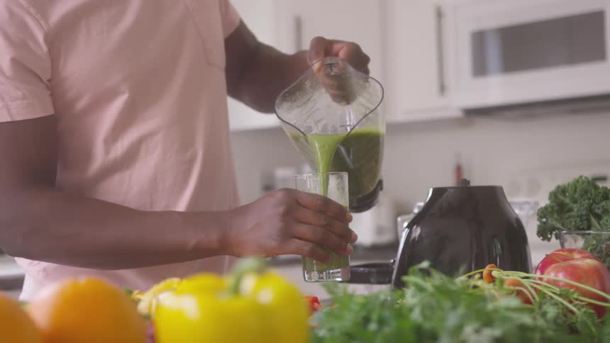 A man is pouring a blending drink