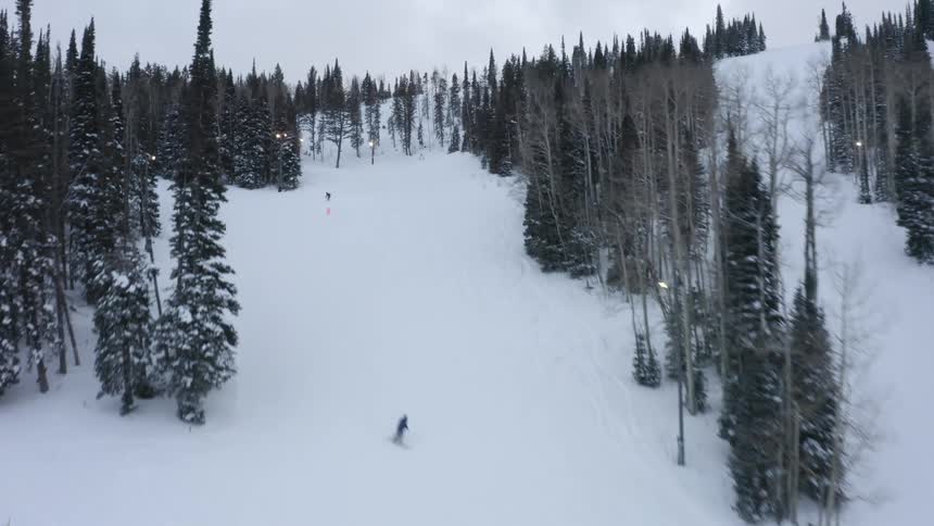 People are skiing and snowboarding on the slopes
