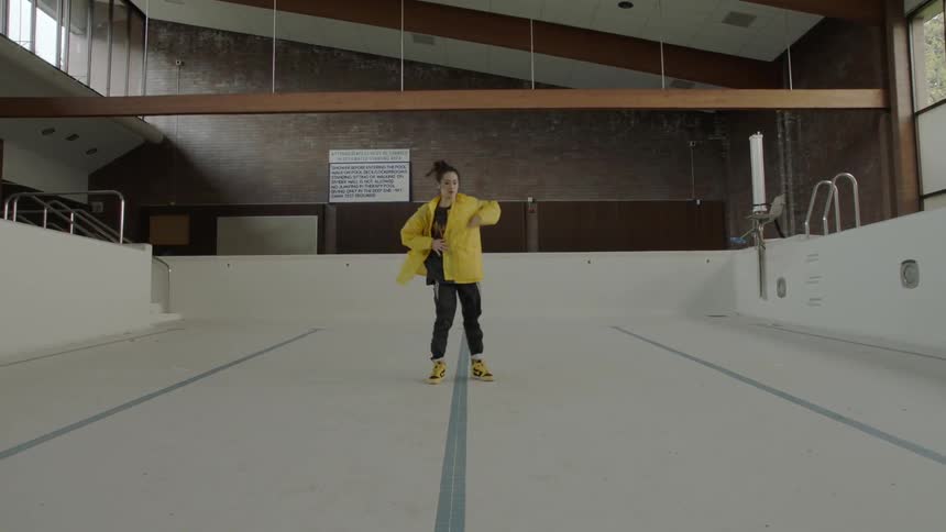 Woman dancing in an empty pool